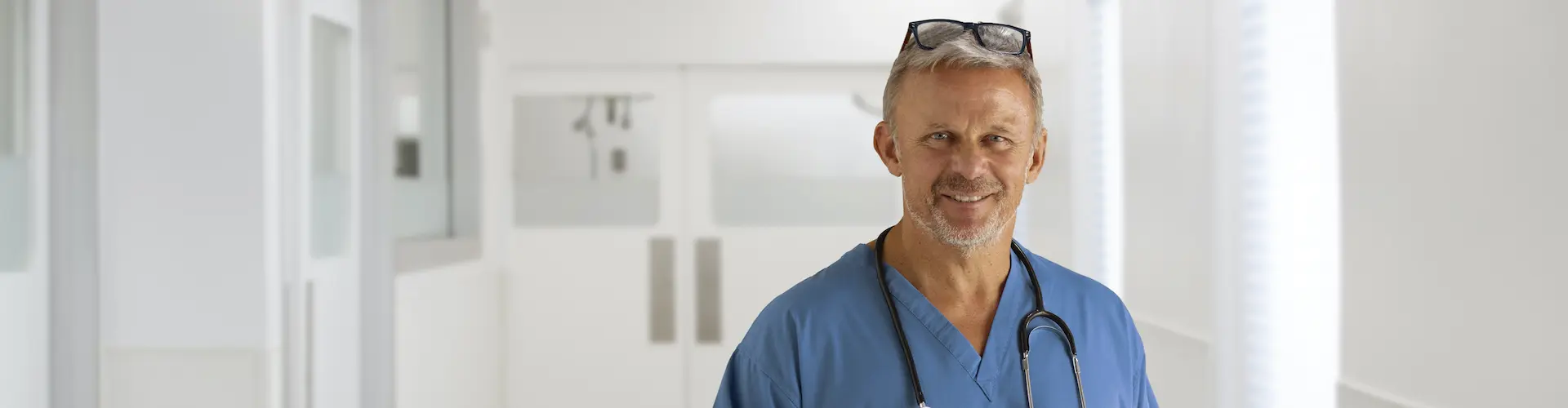 A doctor standing facing the camera