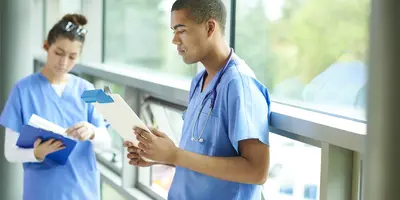 Two nurses in a hospital corridor