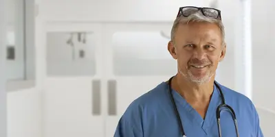 A doctor standing facing the camera