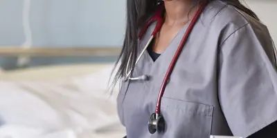 Cropped photo of a doctor in scrubs wearing a stethoscope